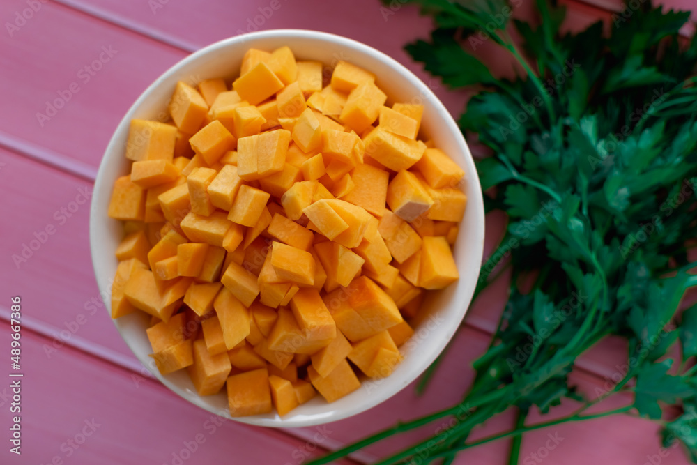 Pumpkin and carrots diced, fresh sweet vegetables, bright orange color, beauty of nature products, raw ingredients for cooking in the kitchen