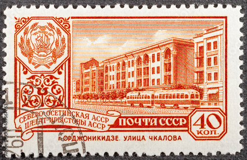 Postage stamp Soviet Union in 1961. Chkalov Street in the capital of North Ossetia - city of Ordzhonikidze - Vladikavkaz. Coat of arms of the Autonomous Republic of Ossetia in USSR. Close-up photo