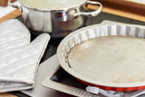 Pie or tart pan and oven glove in a kitchen