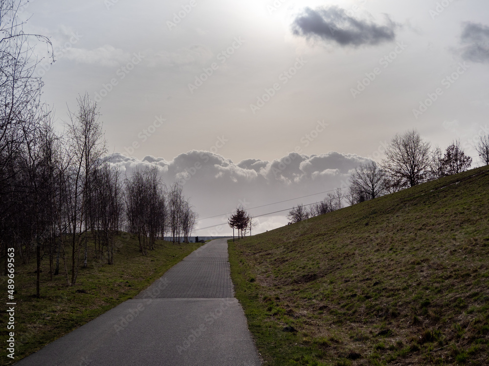 Uphill road. Asphalt path uphill Uphill road. Asphalt path uphill