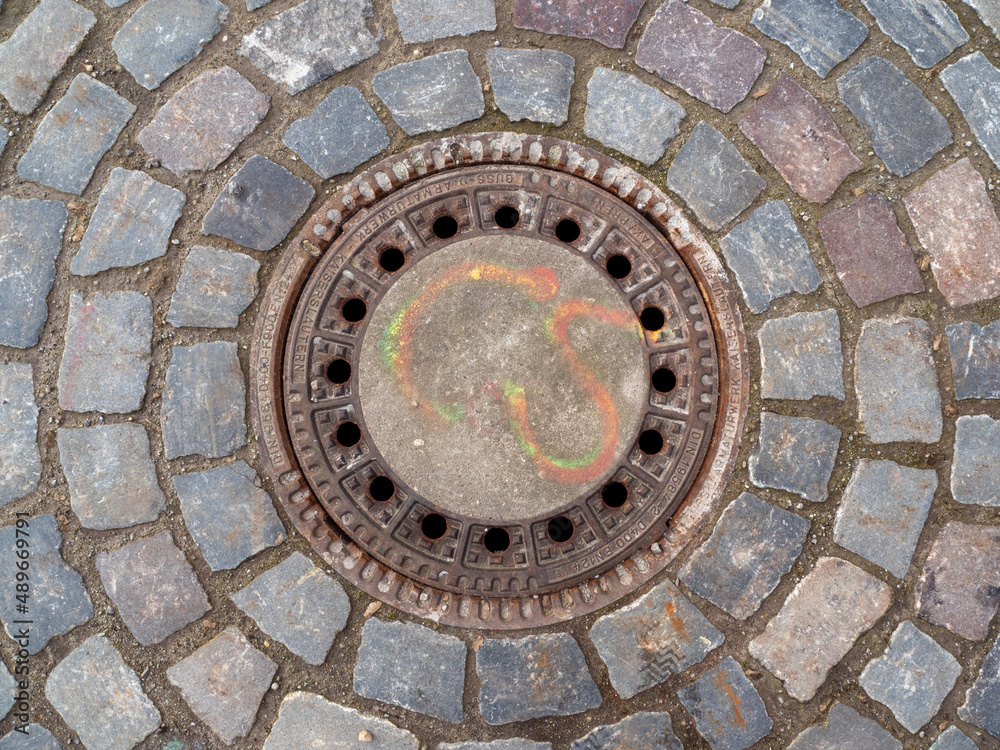 Sewer manhole lined with stones