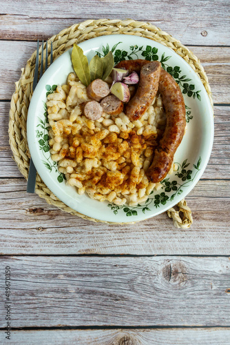 butifarra with beans, Botifarra amb mongetes or Botifarra amb seques, is a traditional dish of Catalan cuisine, based on butifarra and white beans. photo