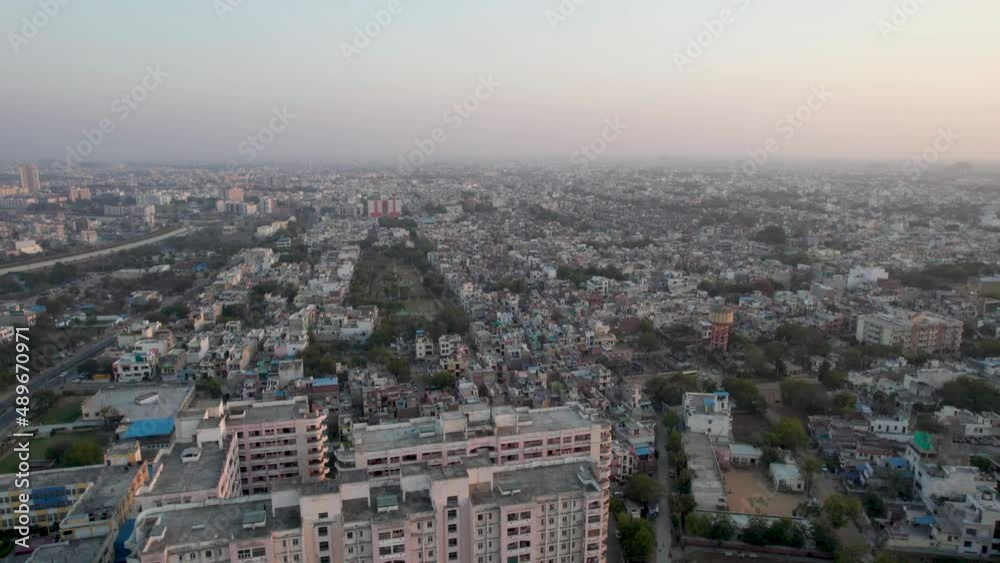 backward slow aerial shot showing densely populated city and skyscraper in front showing the concrete jungle in small indian cities like jaipur, lucknow, noida, gurgaon and other Indian cities backward slow aerial shot showing densely populated city and skyscraper in front showing the concrete jungle in small indian cities like jaipur, lucknow, noida, gurgaon and other Indian cities