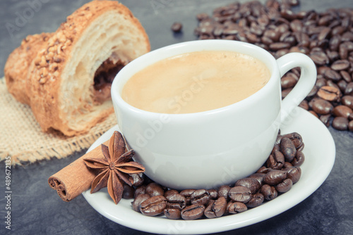 Fototapeta Naklejka Na Ścianę i Meble -  Cup of coffee and fresh croissant with chocolate for breakfast