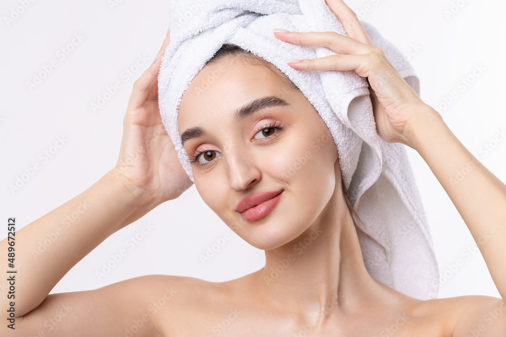 Beautiful girl with thick eyebrows and perfect skin at white background, towel on head, beauty photo. Beautiful girl with thick eyebrows and perfect skin at white background, towel on head, beauty photo.