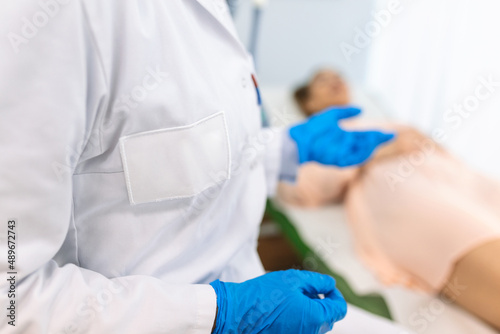 female doctor professional gynecologist examining her patient on a gynecological chair healthcare medicine feminine gynecology concept. © Graphicroyalty