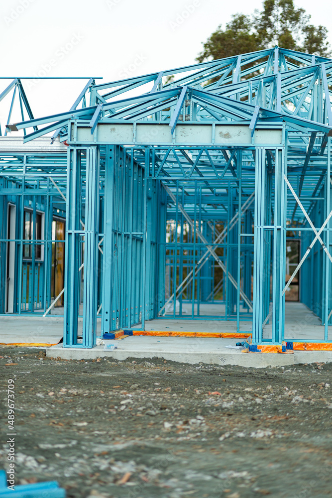 Blue metal frame structure of house being built Blue metal frame structure of house being built