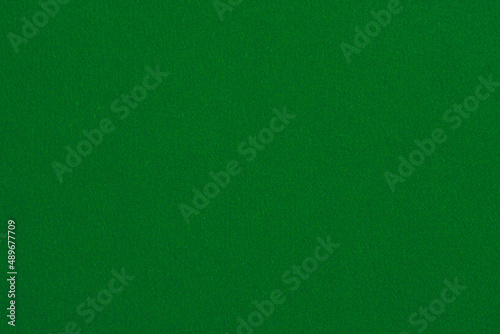 Dark green background with paper fabric canvas texture for layout, collage, coaster. Pure color.