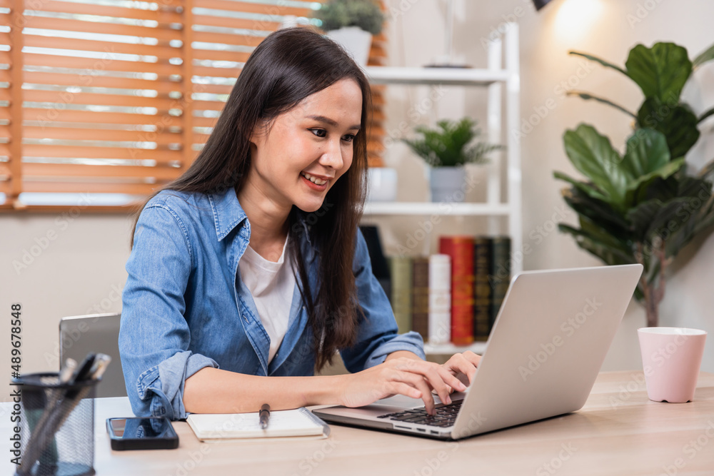 Asian business woman working on laptop at home Asian business woman working on laptop at home