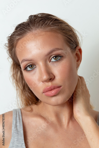 Portraits of a pretty girl with makeup and hair on a white background 