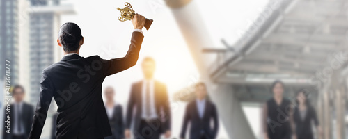 Manager, businessman or boss holding champion golden trophy for winner, success and achievement award in business concept
