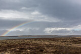 Scenery with dark clouds and rainbow over the raw coast of Snaefellsnes peninsula, Iceland