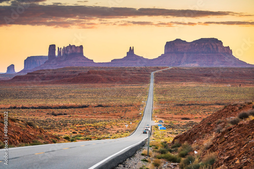 Monument Valley with U.S. Route 163 foreground at sunset.
