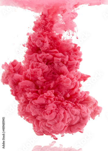 Colorful explosion. Studio shot of pink ink in water against a white background.