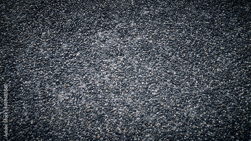 close up of small grey stones - used as background - front view - 16:9 - strong vignette