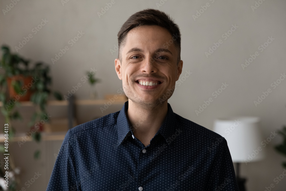 Head shot portrait of happy young 30s Hispanic man showing whitening smile, satisfied with professional dentistry services. joyful confident male homeowner looking at camera, posing in own dwelling. Head shot portrait of happy young 30s Hispanic man showing whitening smile, satisfied with professional dentistry services. joyful confident male homeowner looking at camera, posing in own dwelling.