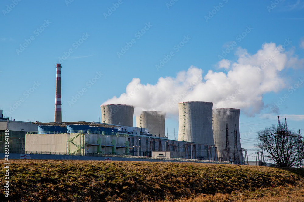 Dukovany Nuclear Power Plant in the Czech Republic, Europe. Smoke cooling towers. There are clouds in the sky. In the background the nature of the Highlands. Dukovany Nuclear Power Plant in the Czech Republic, Europe. Smoke cooling towers. There are clouds in the sky. In the background the nature of the Highlands.