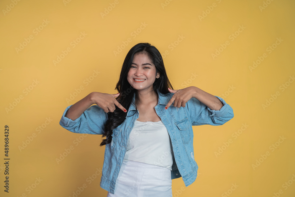 young woman with two finger pointing down young woman with two finger pointing down