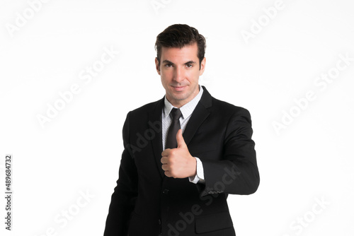 Portrait of a smiling western business man wearing a black suit with thumbs up at studio shot on white background.
