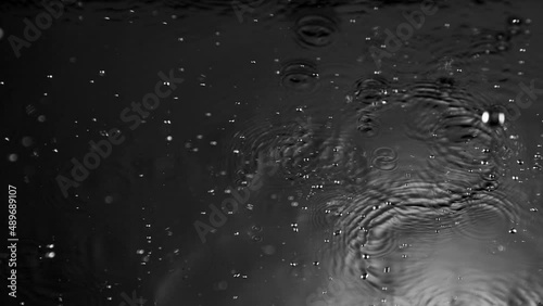 Super Slow Motion Shot of Many Water Drops Falling and Splashing on Surface at 1000fps. photo