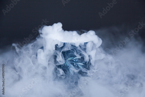 Dry ice vapour made of carbon dioxide spilling out into air photo