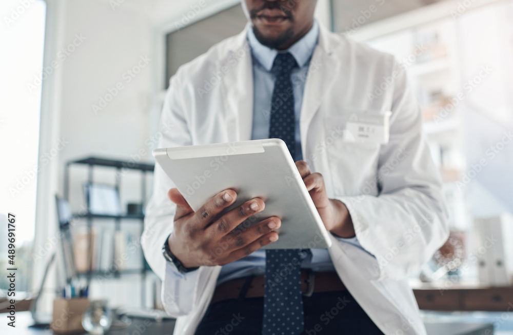 Now I can find information at the tap of a screen. Shot of an unrecognizable doctor using a digital tablet in an office. Now I can find information at the tap of a screen. Shot of an unrecognizable doctor using a digital tablet in an office.