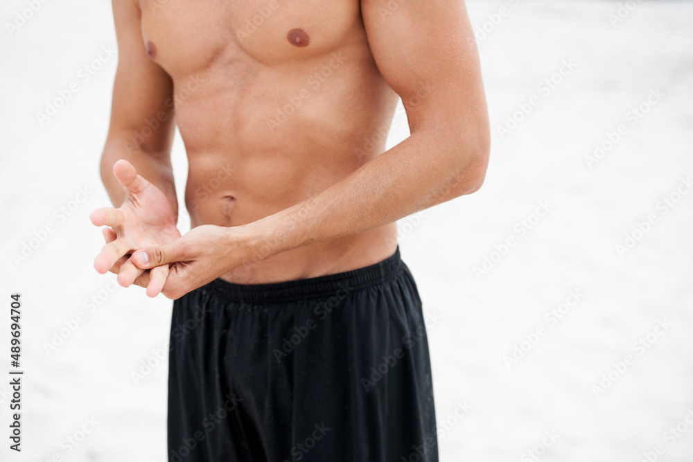 Chiselled chest and abdominals. Cropped image of an attractive man standing shirtless showing his abdominal muscles.