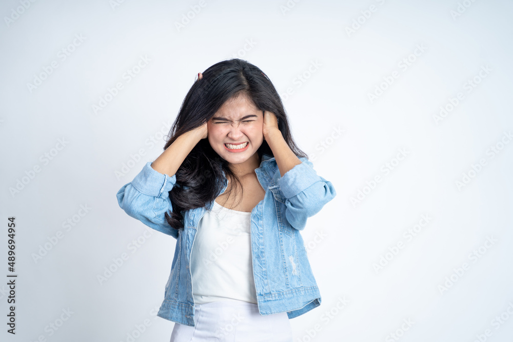 Asian young woman holding head with headache on isolated background Asian young woman holding head with headache on isolated background