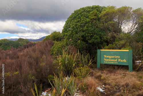 A sign on the outskirts of Tongariro National Park, a World Heritage Area in New Zealand. In the distance is Mount Ruapehu photo