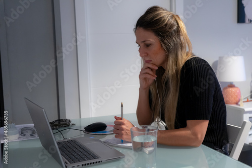 Woman working with computer at home. Online work, business day
