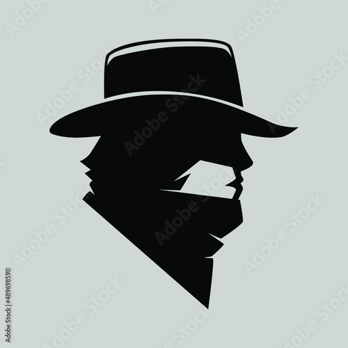 Cowboy masked outlaw symbol side view on gray backdrop. Design element