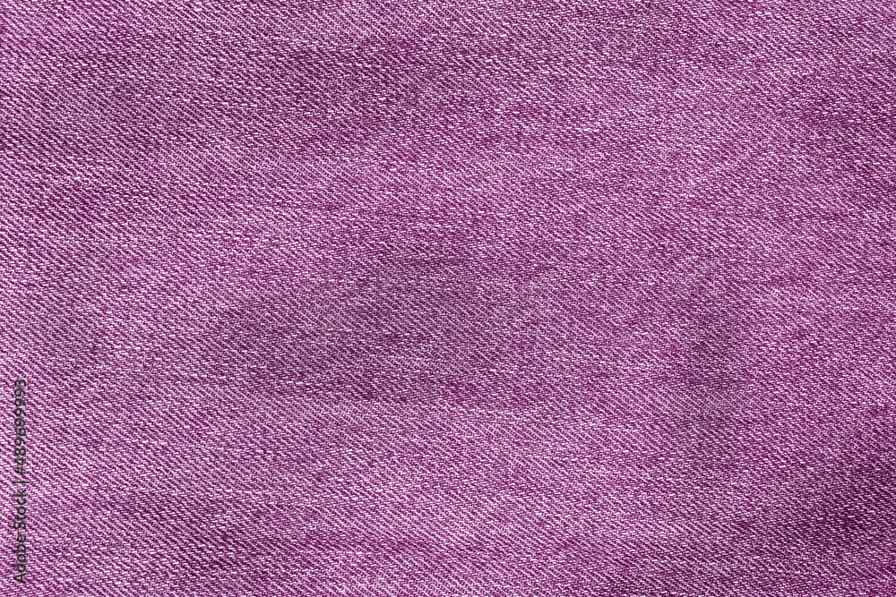 Texture of purple jeans. purple background. Denim