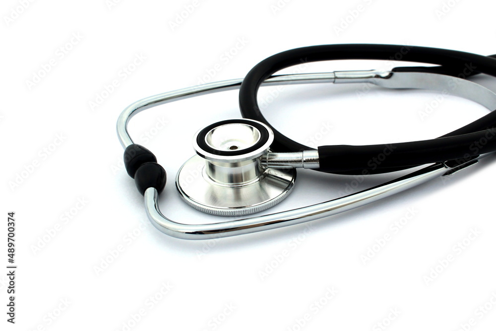 On a white isolated background lies a black stethoscope. On a white isolated background lies a black stethoscope.