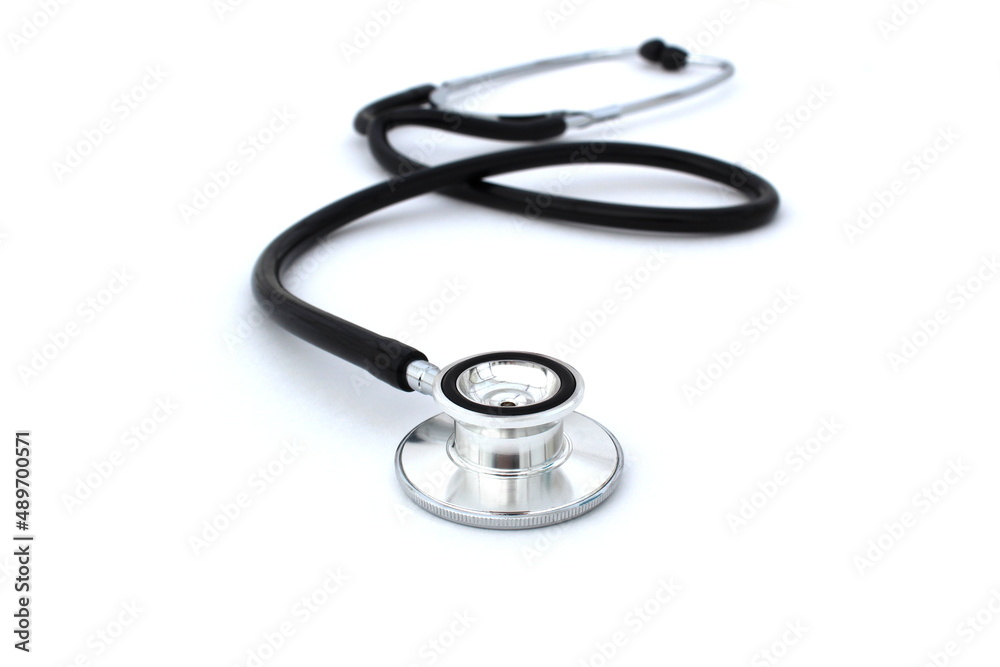 On a white isolated background lies a black stethoscope. On a white isolated background lies a black stethoscope.