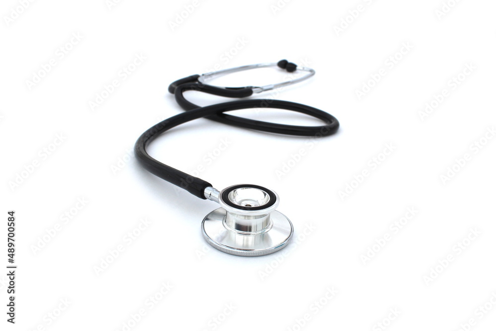 On a white isolated background lies a black stethoscope. On a white isolated background lies a black stethoscope.