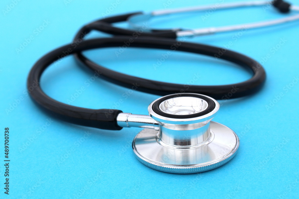 The stethoscope lies on a blue bright background. The stethoscope lies on a blue bright background.
