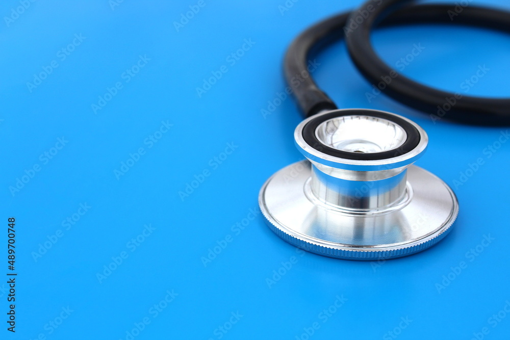 The stethoscope lies on a blue bright background. The stethoscope lies on a blue bright background.