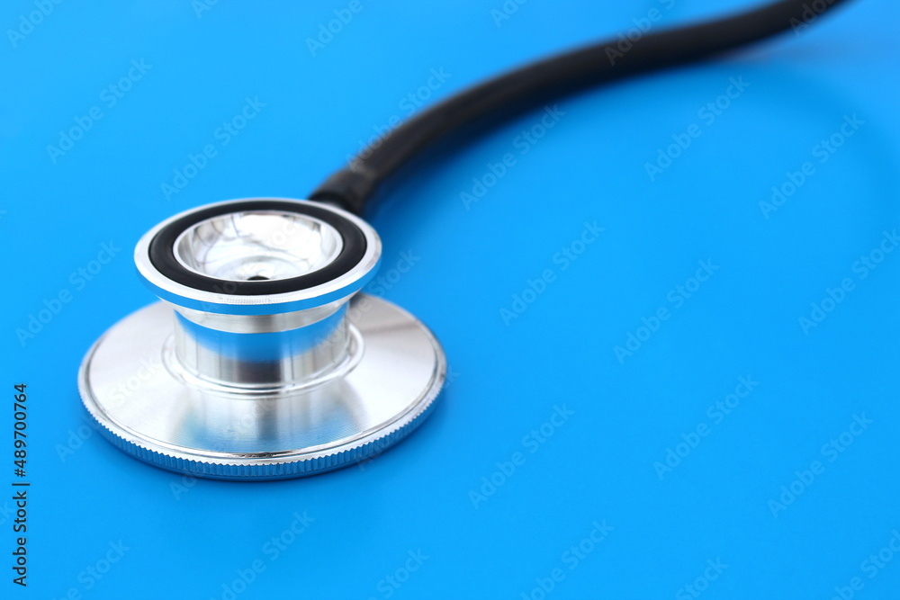 The stethoscope lies on a blue bright background. The stethoscope lies on a blue bright background.
