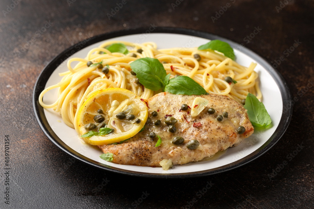 Chicken Piccata with capers, white wine sauce and spaghetti. Italian food