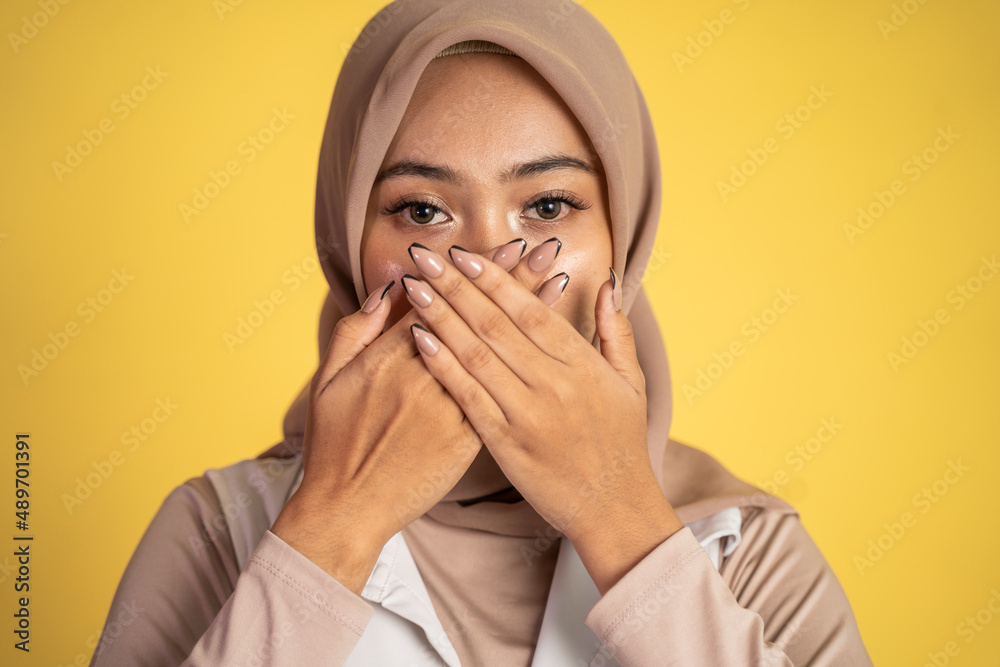 muslim woman with shocked expression with hands covering mouth muslim woman with shocked expression with hands covering mouth