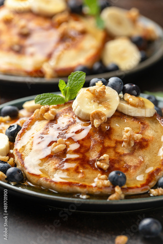 American pancakes with banana  blueberry  walnut and honey. Healthy morning breakfast
