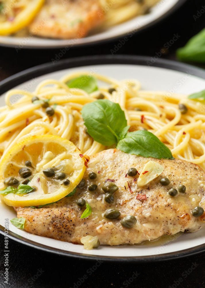 Chicken Piccata with capers, white wine sauce and spaghetti. Italian food Chicken Piccata with capers, white wine sauce and spaghetti. Italian food