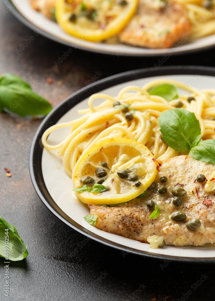 Chicken Piccata with capers, white wine sauce and spaghetti. Italian food Chicken Piccata with capers, white wine sauce and spaghetti. Italian food