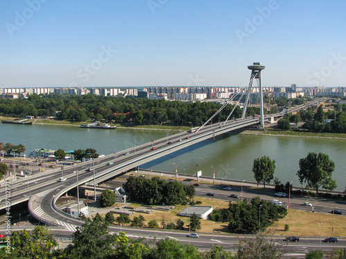 SNP bridge over the Danube River in Bratislava, Slovakia. Panoramatic view with Danube river, taken on a clear summer day. Image has copy space.
