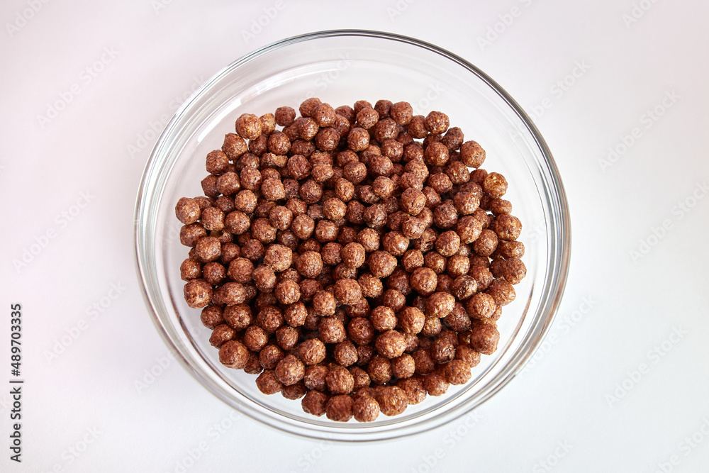 Granola in a transparent bowl on a white background. Healthy food. Granola in a transparent bowl on a white background. Healthy food.