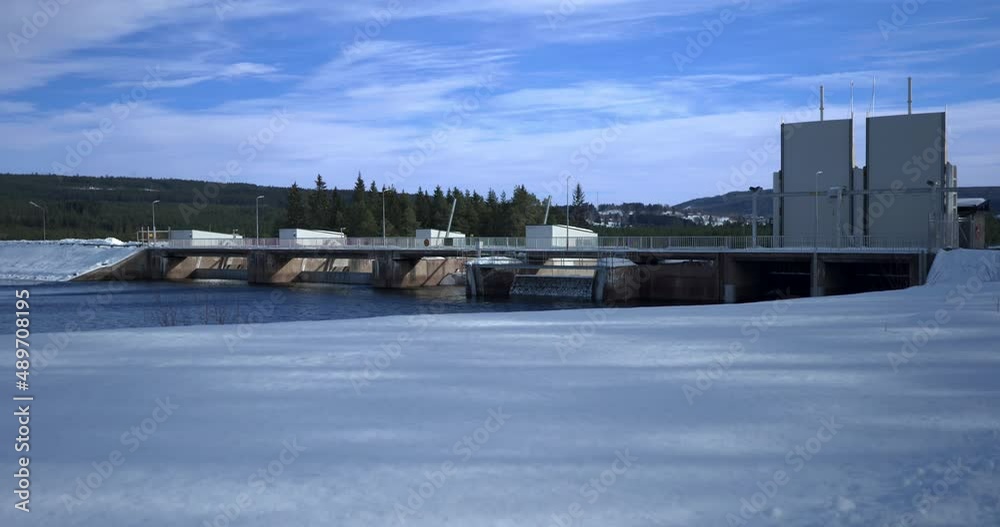 A Water Power Station in Dalarna, Sweden during a Cold Winter day. Static wide shot. A Water Power Station in Dalarna, Sweden during a Cold Winter day. Static wide shot.