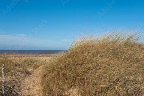 A view over Hunstanton beach on the North Norfolk coast taken from the sand dunes. Captured on a bright and sunny day in the winter