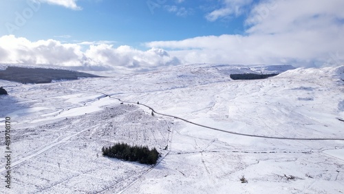 Vászonkép Aerial image of a road through bleak snow-covered moorland