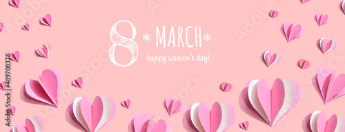 Happy women's day message with pink paper hearts - flat lay