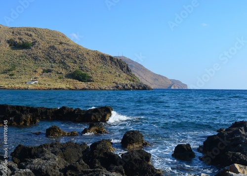 Clear blue water and rocks. Rocky seashore in Greece, Crete.